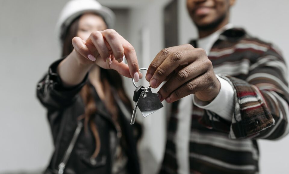 A Couple Holding their House Key